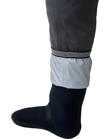 Detail of BRIVER wader neoprene stockingfoot featuring built-in gravel guards with non-slip elastic cuffs to keep debris out.