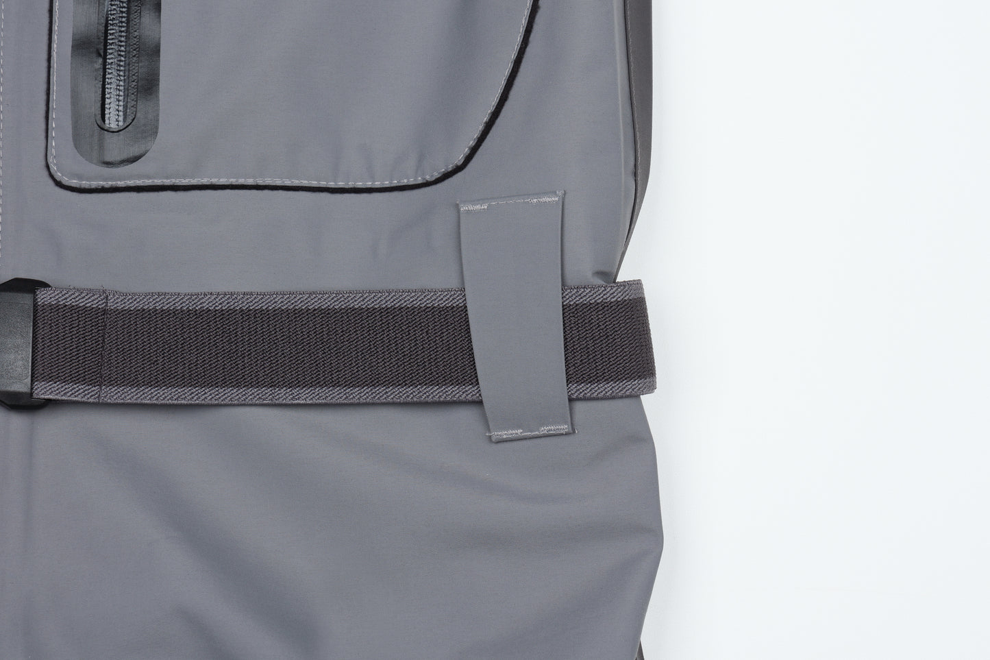Close-up of BRIVER wader waist featuring heavy-duty reinforced belt loops and a durable nylon wading belt for a secure fit.